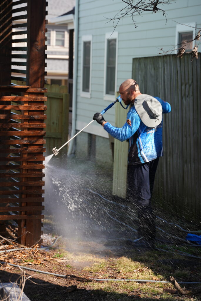 Wash Nash TN technician soft washing at a Nashville home